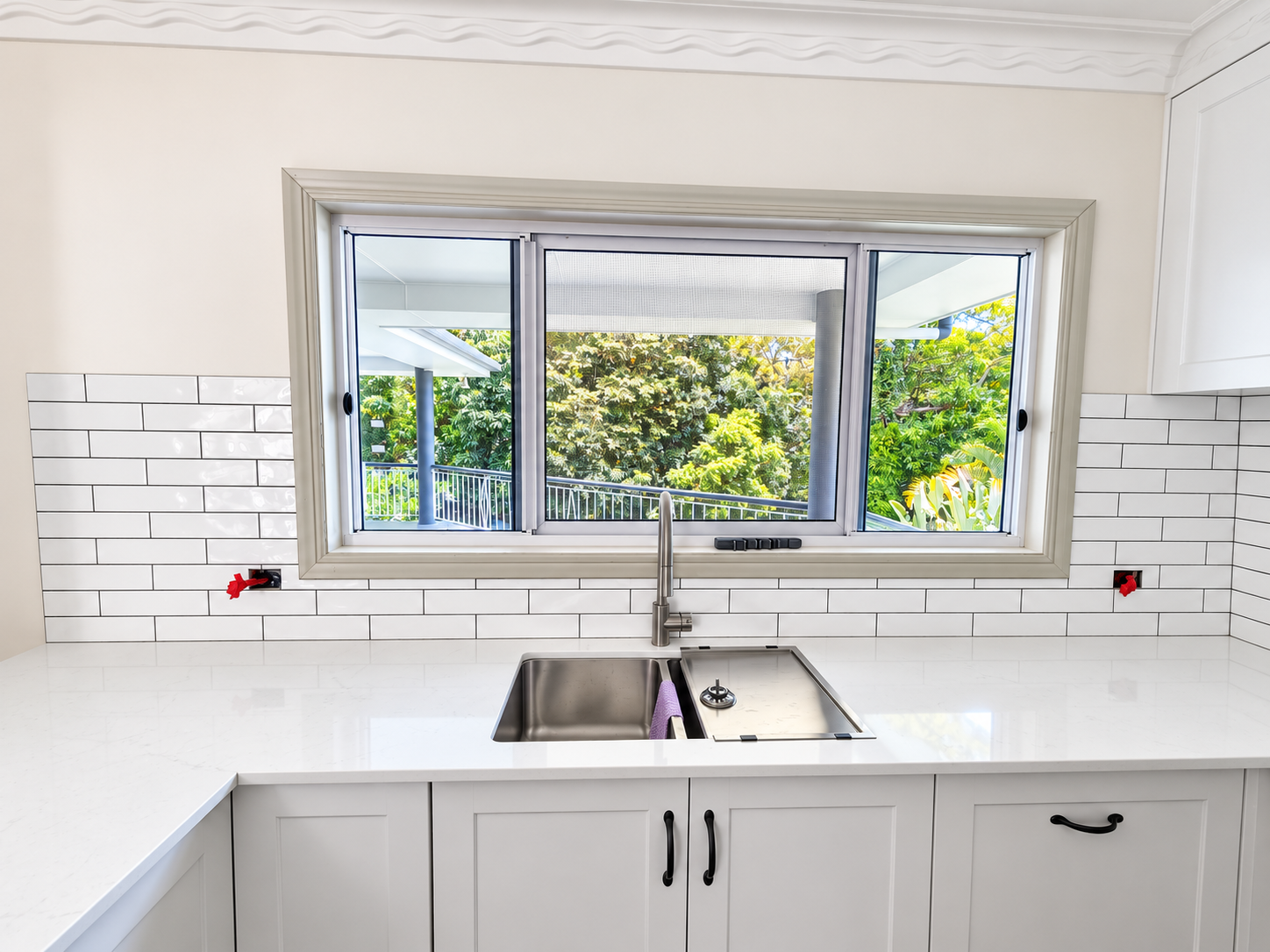 Placeholder: vertical stacked ceramic splashback with charcoal cabinetry